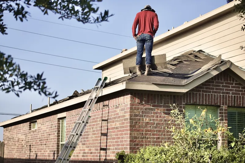 Professional roofer working on a residential roof in Florecita Farm